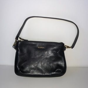 Black leather Fossil handbag with gold accents.